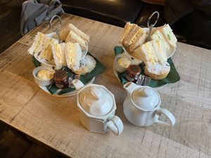 Small sandwiches and tea representing afternoon tea